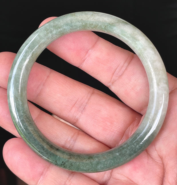 Solid icy apple green and milky white natural Type A Burmese jade bangle bracelet in size 56.8mm