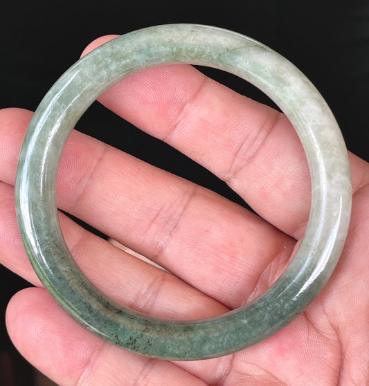 Solid icy apple green and milky white natural Type A Burmese jade bangle bracelet in size 56.8mm