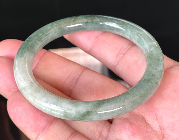 Solid icy apple green and milky white natural Type A Burmese jade bangle bracelet in size 56.8mm