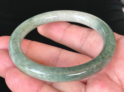 Solid icy apple green and milky white natural Type A Burmese jade bangle bracelet in size 56.8mm