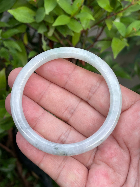 Solid icy greyish white and green natural Type A Burmese jade bangle bracelet in size 56.7mm