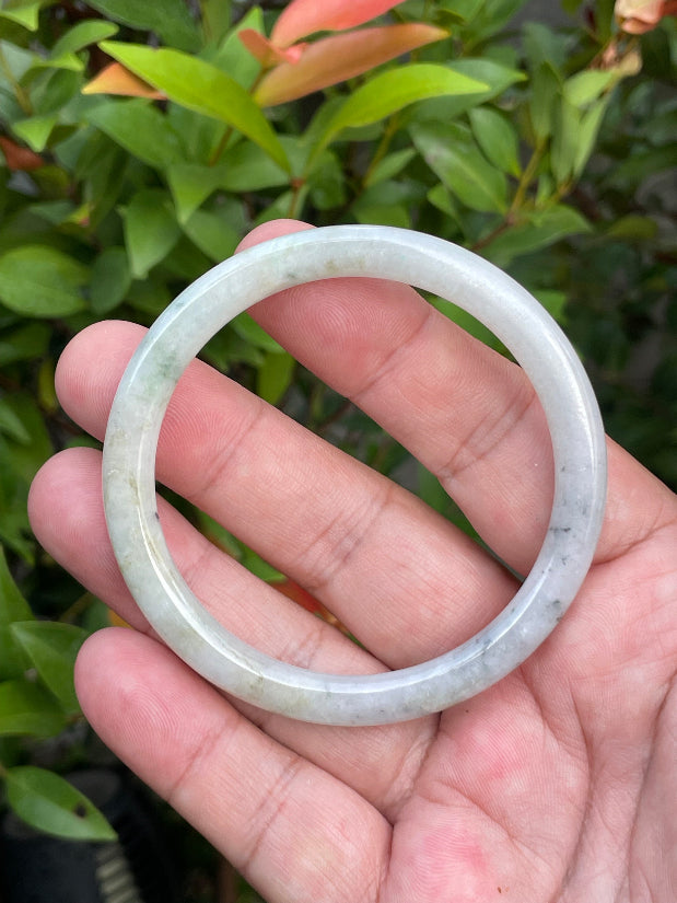 Solid icy greyish white and green natural Type A Burmese jade bangle bracelet in size 56.7mm