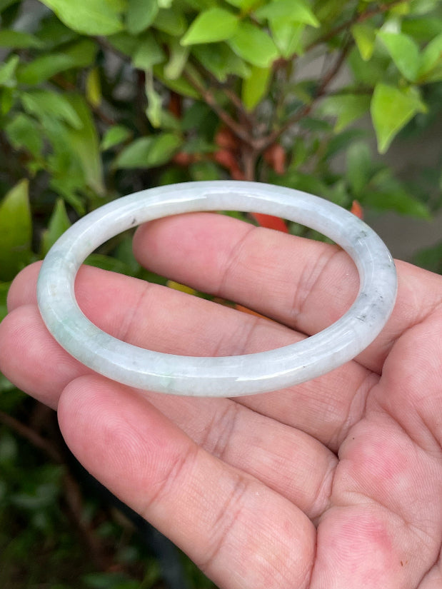 Solid icy greyish white and green natural Type A Burmese jade bangle bracelet in size 56.7mm