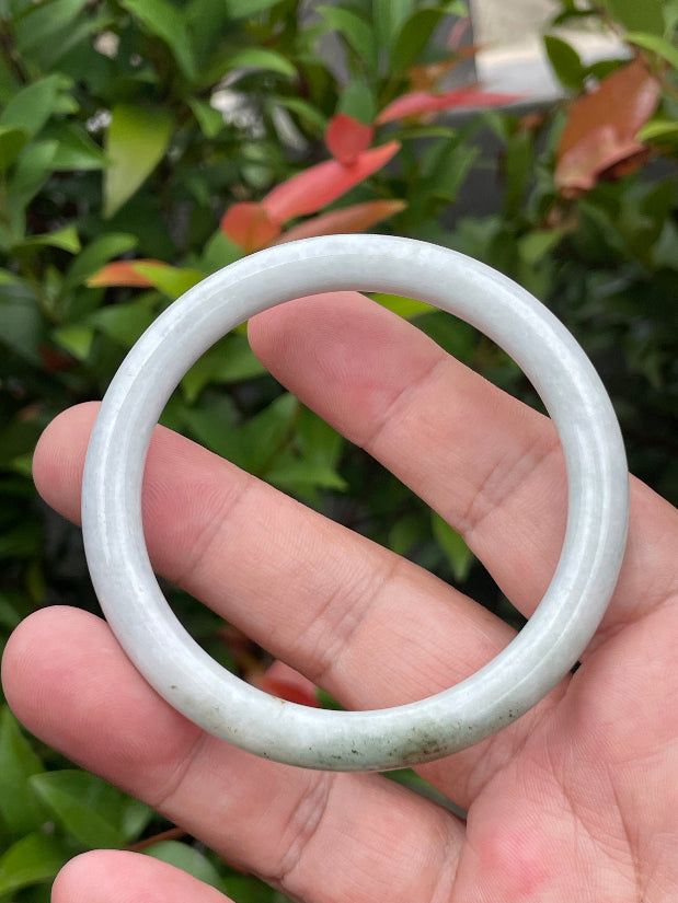 Solid icy milky white and moss green natural Type A Burmese jade bangle bracelet in size 55.9mm