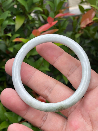 Solid icy milky white and moss green natural Type A Burmese jade bangle bracelet in size 55.9mm