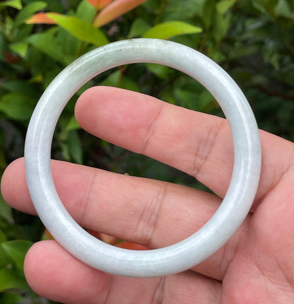 Solid icy milky white and moss green natural Type A Burmese jade bangle bracelet in size 55.9mm