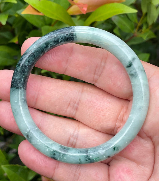 Solid bluish apple green and black natural Type A Burmese jade bangle bracelet in size 57mm