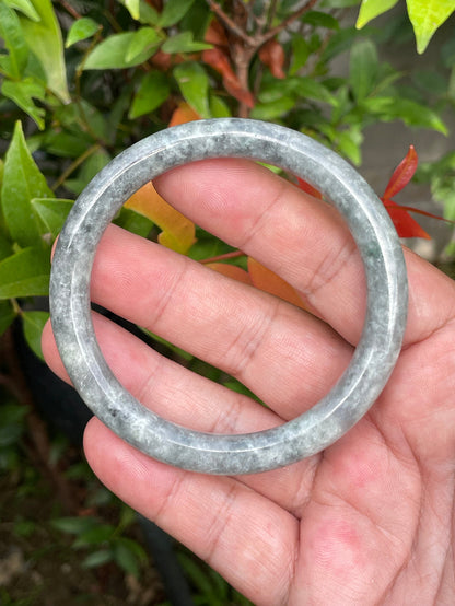 Solid icy grayish black and milky white natural Type A Burmese jade bangle bracelet in size 59.2mm