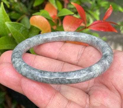 Solid icy grayish black and milky white natural Type A Burmese jade bangle bracelet in size 59.2mm