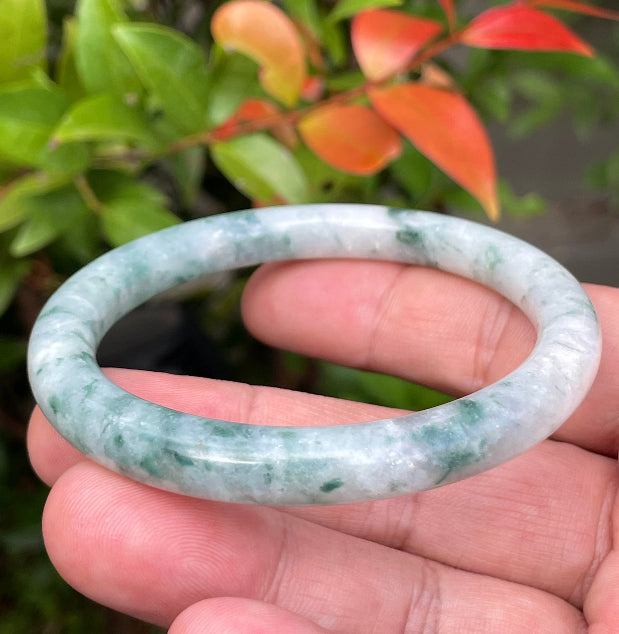 Solid icy bluish green and milky white natural Type A Burmese jade bangle bracelet in size 58.7mm
