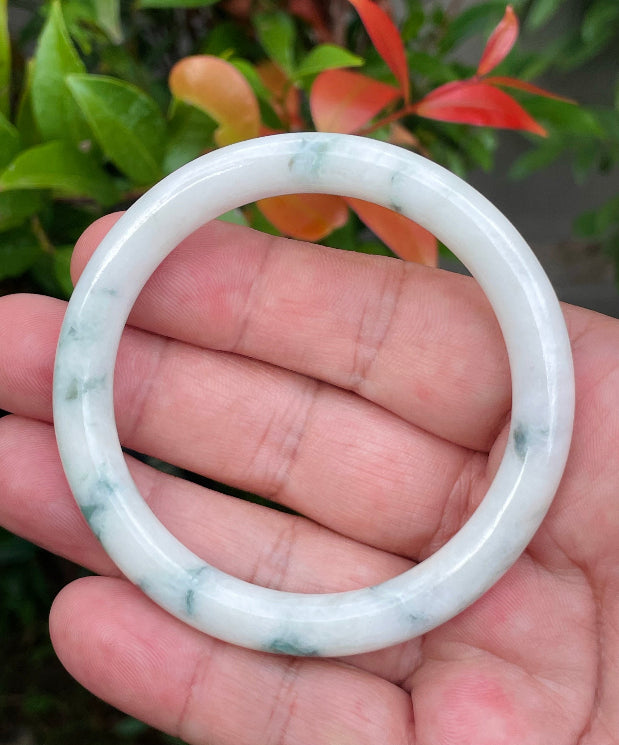 Solid icy milky white and apple green natural Type A Burmese jade bangle bracelet in size 55.3mm