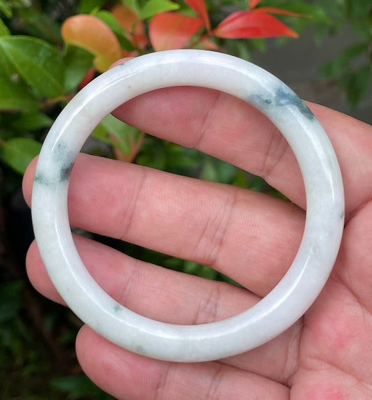 Solid icy imperial green and milky white natural Type A Burmese jade bangle bracelet in size 55.4mm