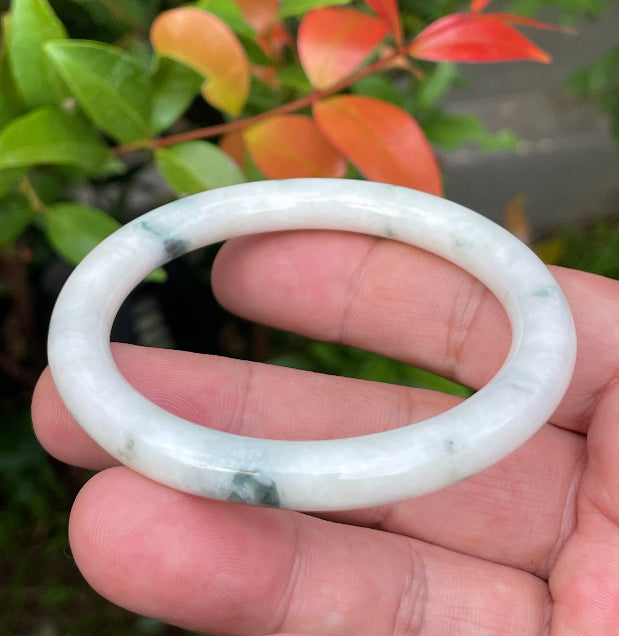 Solid icy imperial green and milky white natural Type A Burmese jade bangle bracelet in size 55.4mm