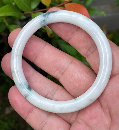 Solid icy imperial green and milky white natural Type A Burmese jade bangle bracelet in size 55.4mm