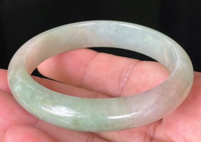Rounded classic profile of 57mm icy apple green and milky white Burmese jade bangle JB079