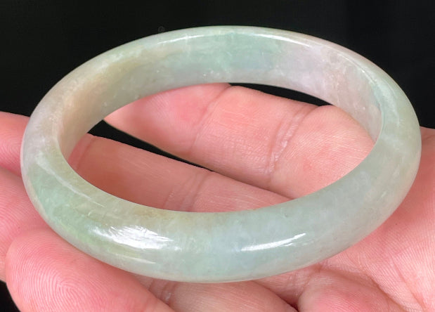 Rounded classic profile of 57mm icy apple green and milky white Burmese jade bangle JB079