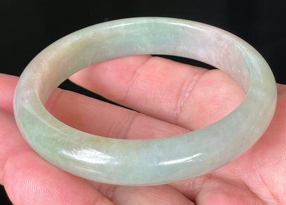 Rounded classic profile of 57mm icy apple green and milky white Burmese jade bangle JB079