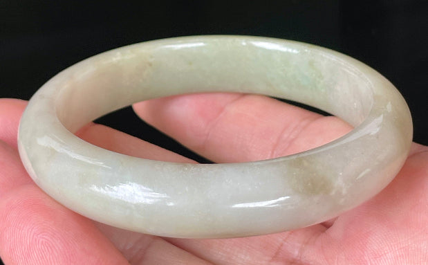 Rounded classic profile of 58.5mm icy apple green, brown and greyish white Burmese jade bangle JB091