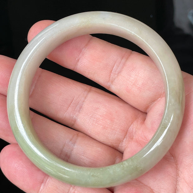 Rounded classic profile of 58.5mm icy apple green, brown and greyish white Burmese jade bangle JB091