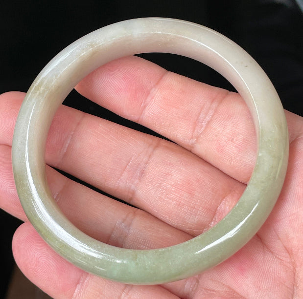 Rounded classic profile of 58.5mm icy apple green, brown and greyish white Burmese jade bangle JB091