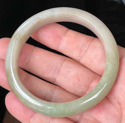 Rounded classic profile of 58.5mm icy apple green, brown and greyish white Burmese jade bangle JB091