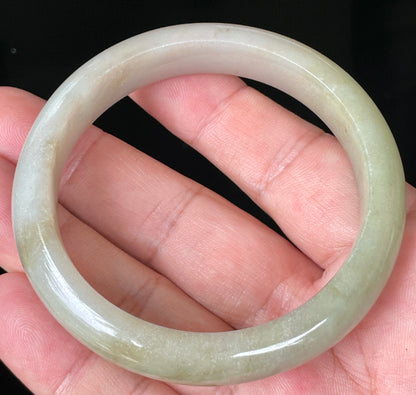 Rounded classic profile of 58.5mm icy apple green, brown and greyish white Burmese jade bangle JB091