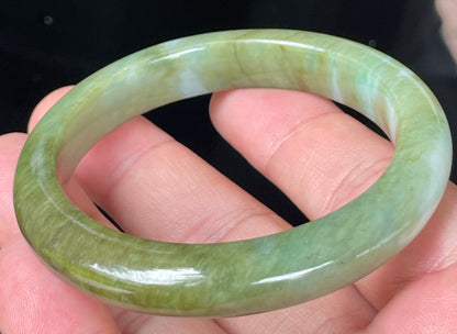 Rounded classic profile of 54.7mm icy forest green, bluish and milky white Burmese jade bangle JB353