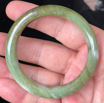 Rounded classic profile of 54.7mm icy forest green, bluish and milky white Burmese jade bangle JB353