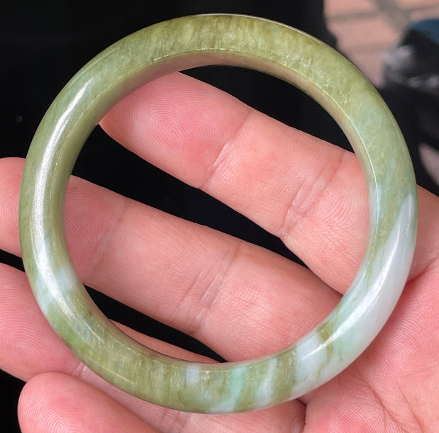 Rounded classic profile of 54.7mm icy forest green, bluish and milky white Burmese jade bangle JB353