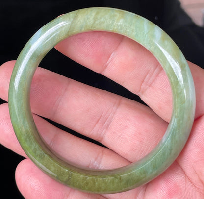 Rounded classic profile of 54.7mm icy forest green, bluish and milky white Burmese jade bangle JB353