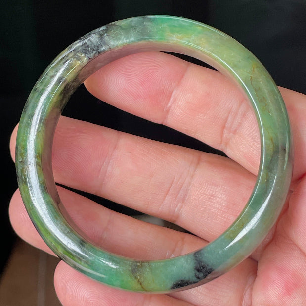 Rounded classic profile of 54.5mm icy green, black and honey Burmese jade bangle JB351