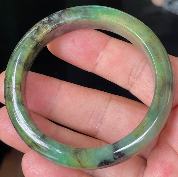 Rounded classic profile of 54.5mm icy green, black and honey Burmese jade bangle JB351
