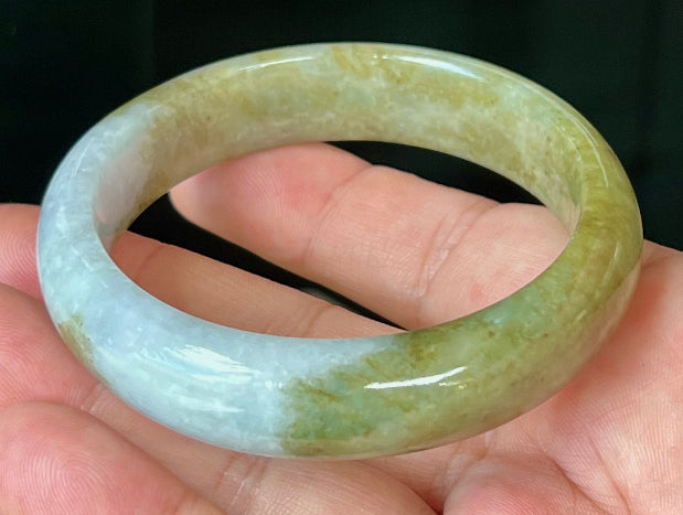 Rounded classic profile of 58.6mm icy green and honey Burmese jade bangle JB521