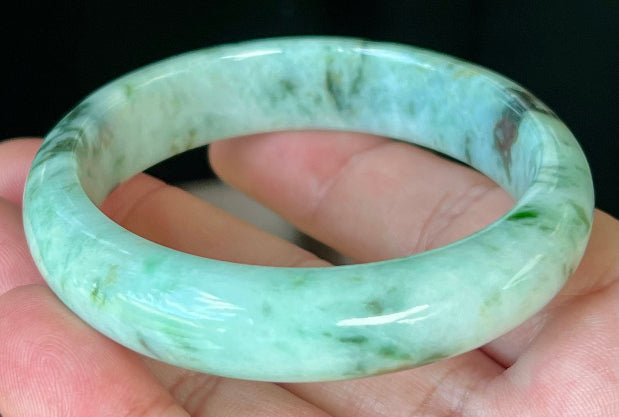 Rounded classic profile of 55.3mm icy green and black Burmese jade bangle JB543