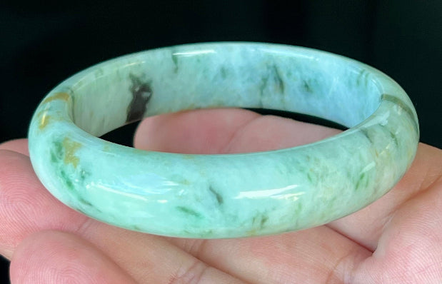 Rounded classic profile of 55.3mm icy green and black Burmese jade bangle JB543