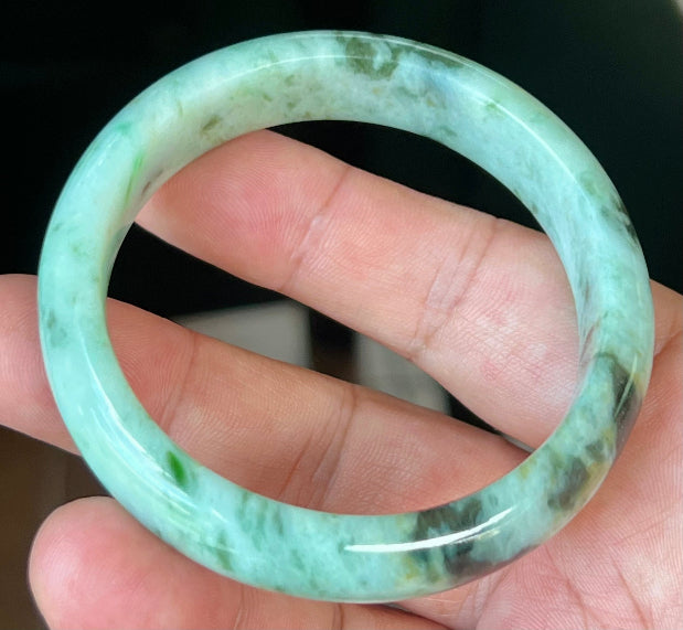 Rounded classic profile of 55.3mm icy green and black Burmese jade bangle JB543