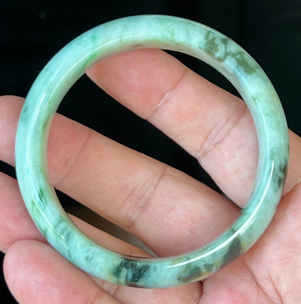 Rounded classic profile of 55.3mm icy green and black Burmese jade bangle JB543