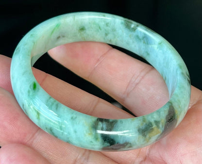 Rounded classic profile of 55.3mm icy green and black Burmese jade bangle JB543