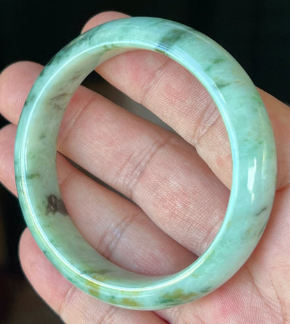 Rounded classic profile of 55.3mm icy green and black Burmese jade bangle JB543