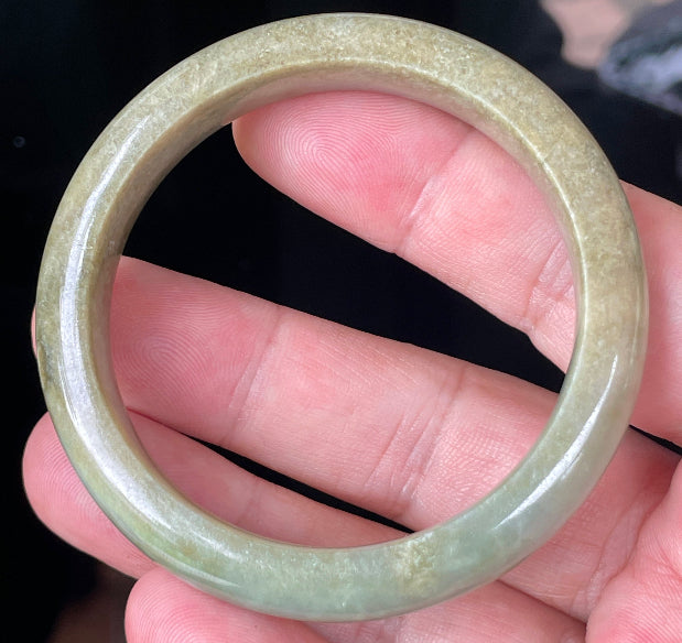 Rounded classic profile of 53mm icy apple green, white and honey brown Burmese jade bangle JB355