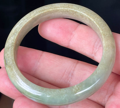 Rounded classic profile of 53mm icy apple green, white and honey brown Burmese jade bangle JB355