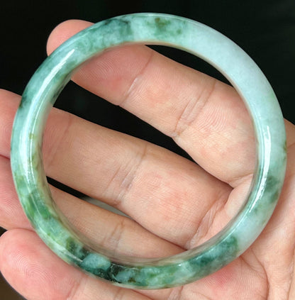 Rounded classic profile of 57.7mm icy apple green and black Burmese jade bangle JB561