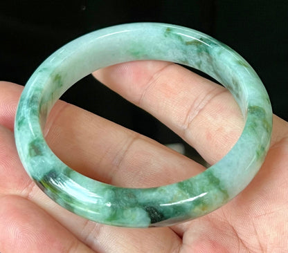 Rounded classic profile of 57.7mm icy apple green and black Burmese jade bangle JB561