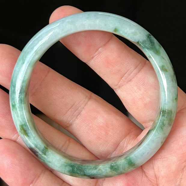 Rounded classic profile of 57.7mm icy apple green and black Burmese jade bangle JB561