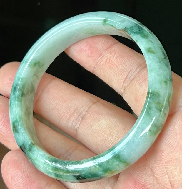 Rounded classic profile of 57.7mm icy apple green and black Burmese jade bangle JB561