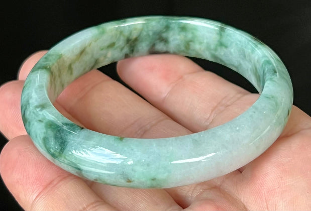 Rounded classic profile of 57.7mm icy apple green and black Burmese jade bangle JB561