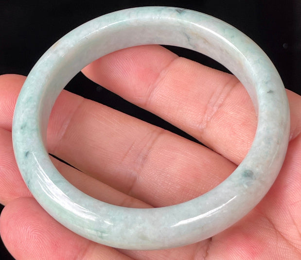 Rounded classic profile of 53mm icy apple green, white and honey brown Burmese jade bangle JB355