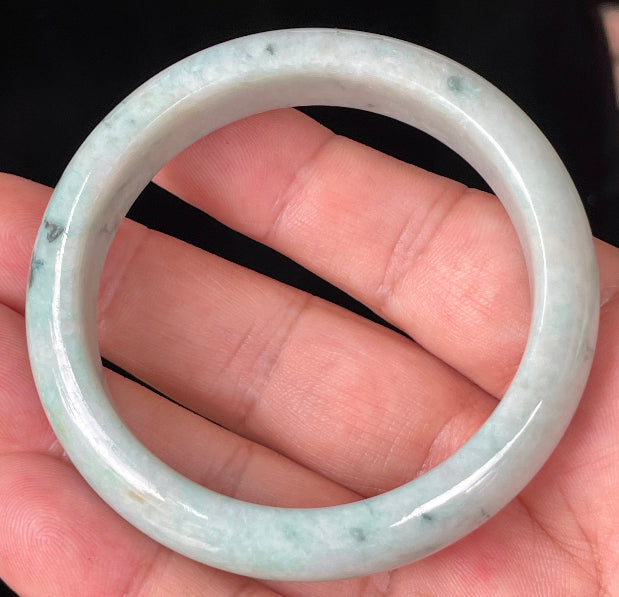 Rounded classic profile of 53mm icy apple green, white and honey brown Burmese jade bangle JB355
