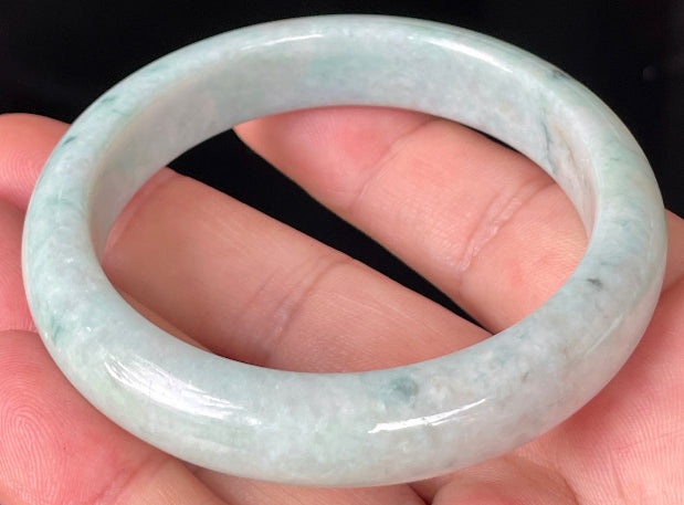 Rounded classic profile of 53mm icy apple green, white and honey brown Burmese jade bangle JB355