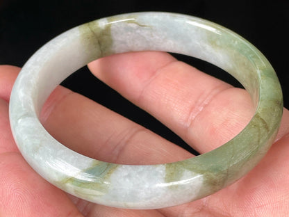 Rounded classic profile of 57mm icy greyish white and apple green Burmese jade bangle JB360
